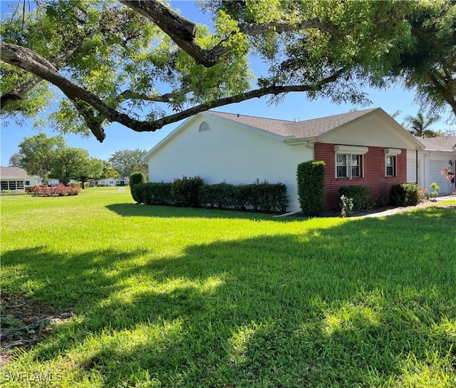 view of side of home with a lawn and a garage