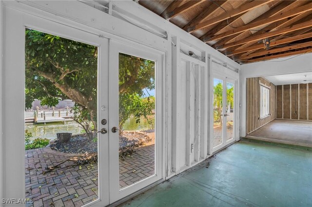 doorway to outside with french doors and lofted ceiling