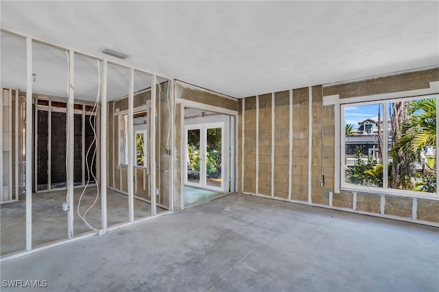 miscellaneous room featuring plenty of natural light and concrete flooring