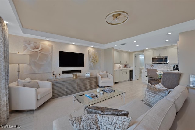 living room featuring wine cooler and sink