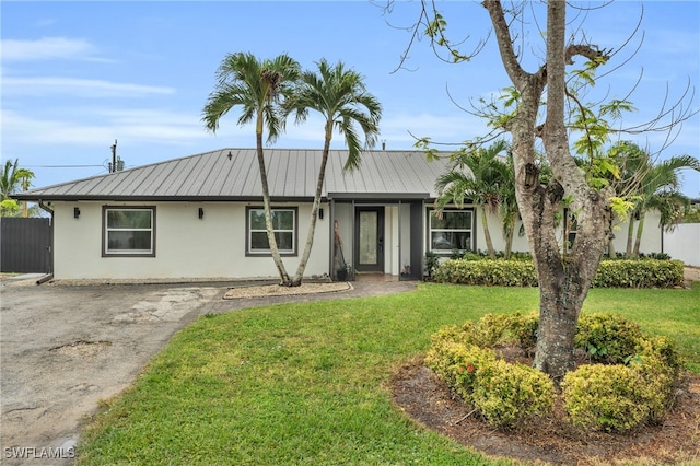 ranch-style home with a front lawn