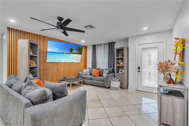 living room featuring light tile patterned floors and ceiling fan