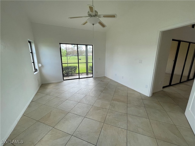 unfurnished room with ceiling fan and light tile patterned flooring