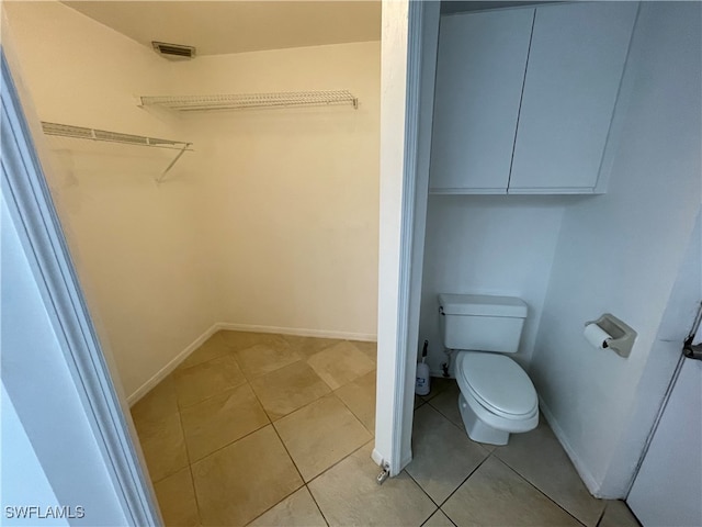 bathroom featuring tile patterned floors and toilet