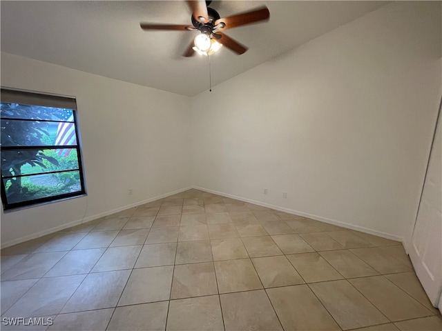 spare room featuring light tile patterned floors, ceiling fan, and lofted ceiling