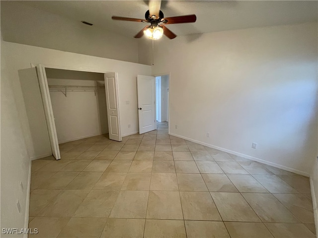 unfurnished bedroom featuring ceiling fan, light tile patterned floors, and a closet