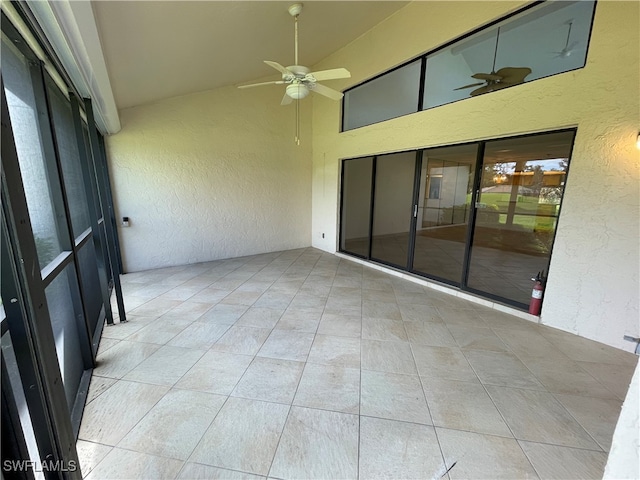 unfurnished sunroom with ceiling fan and lofted ceiling