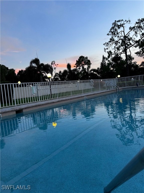 view of pool at dusk