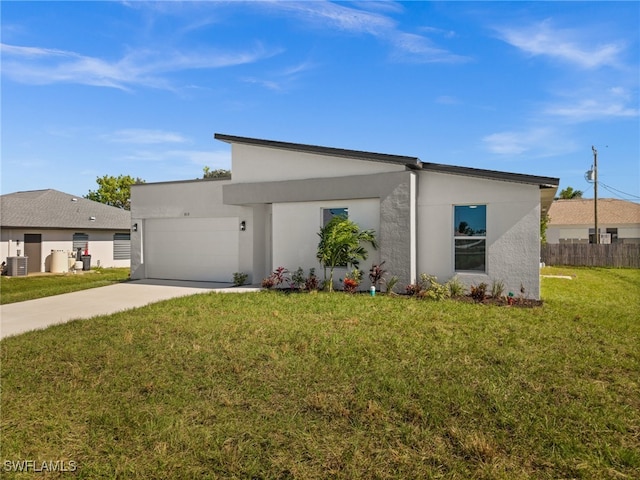 view of front facade with a front yard and a garage