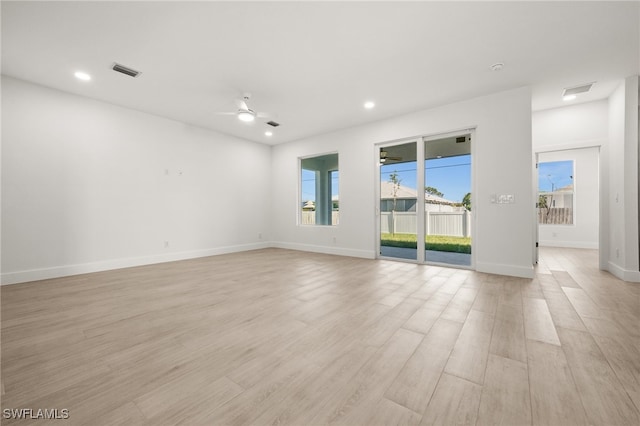 spare room featuring light hardwood / wood-style flooring and ceiling fan