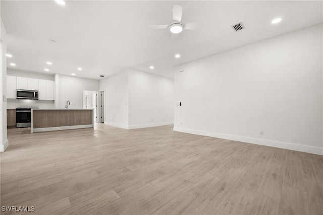 unfurnished living room with light hardwood / wood-style floors and ceiling fan