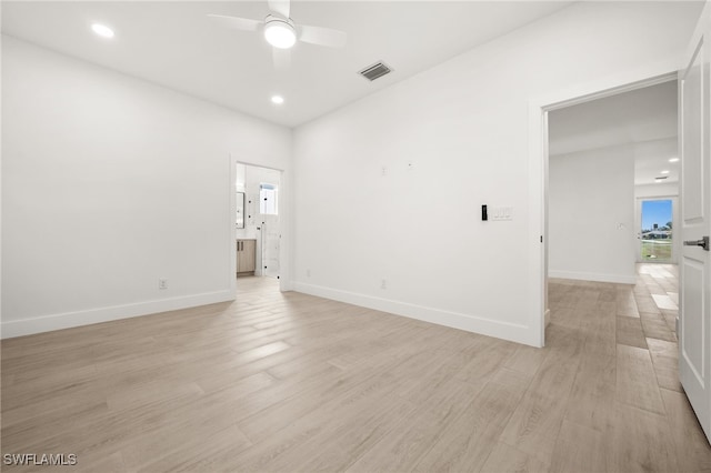 empty room featuring ceiling fan and light hardwood / wood-style flooring