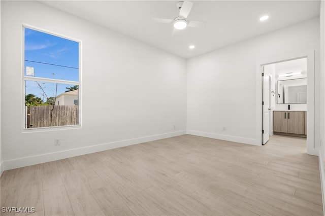 empty room with light hardwood / wood-style flooring and ceiling fan