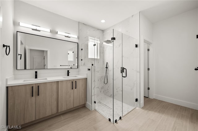 bathroom featuring vanity and a shower with door