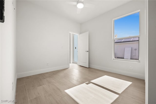 empty room featuring ceiling fan and light hardwood / wood-style floors