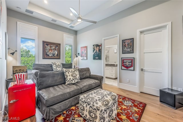 living room with light hardwood / wood-style floors and ceiling fan