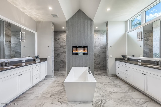 bathroom featuring vanity, plus walk in shower, and tile walls