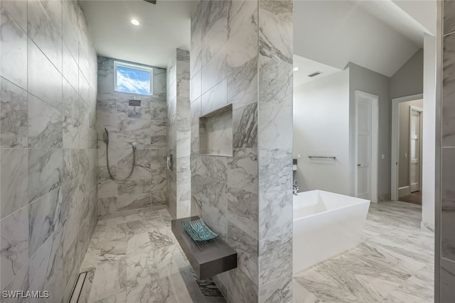 bathroom featuring vaulted ceiling and independent shower and bath