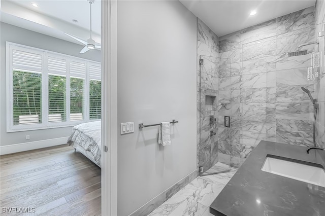 bathroom with ceiling fan, hardwood / wood-style floors, vanity, and walk in shower