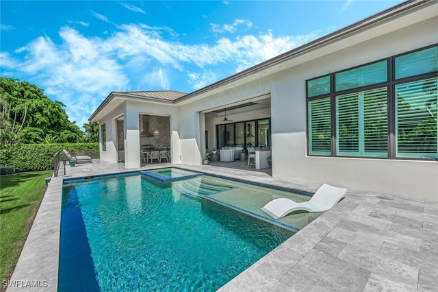 view of pool with an in ground hot tub and a patio