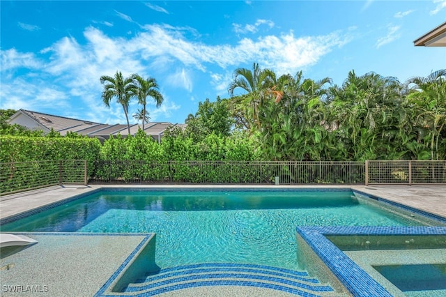 view of swimming pool with an in ground hot tub