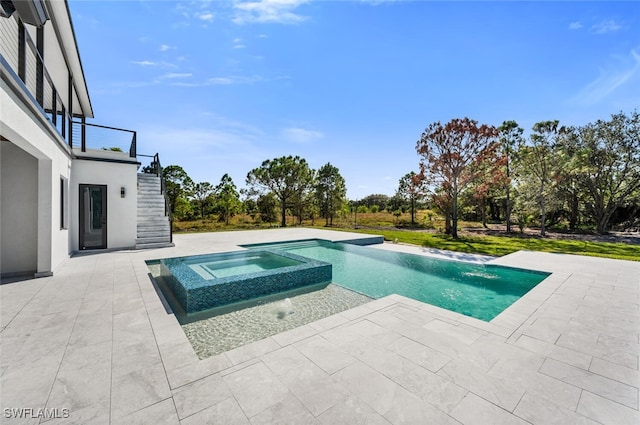 view of pool featuring stairway, a patio area, and a pool with connected hot tub