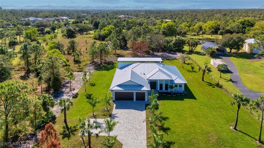 drone / aerial view featuring a view of trees