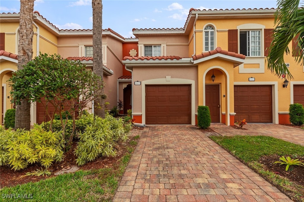 mediterranean / spanish-style home with a garage