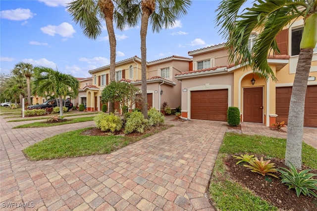 mediterranean / spanish-style house with a garage