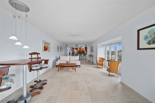 living room with crown molding, ceiling fan, and light hardwood / wood-style floors