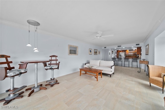 living room with crown molding and ceiling fan