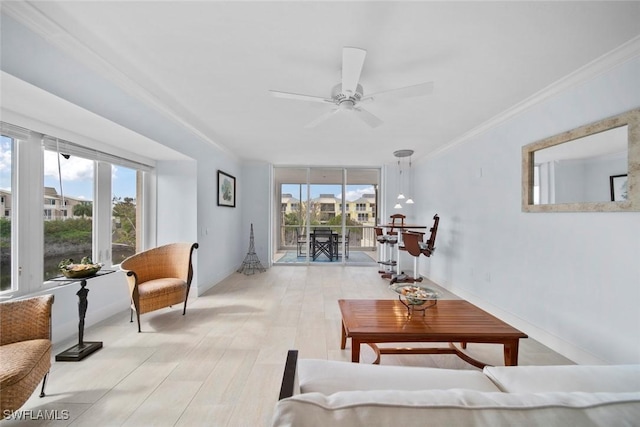 living room with light hardwood / wood-style flooring, plenty of natural light, and ornamental molding