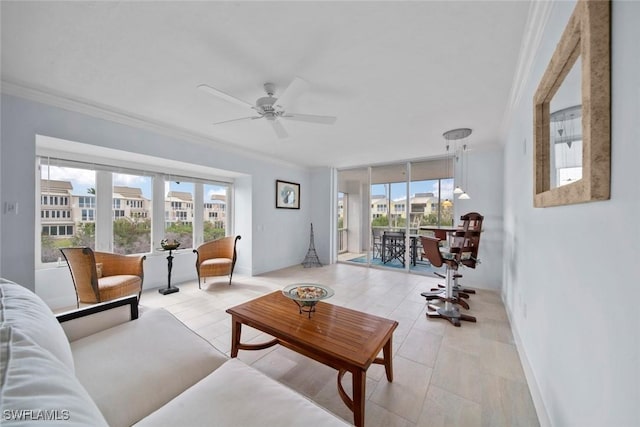 living room with ceiling fan, crown molding, and a healthy amount of sunlight