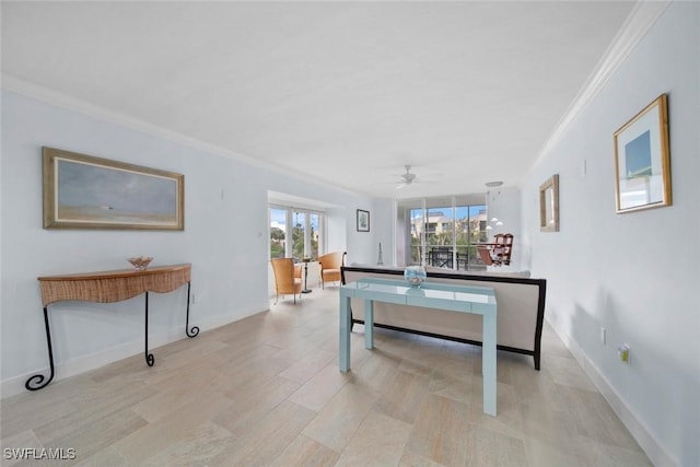 interior space with ceiling fan and ornamental molding