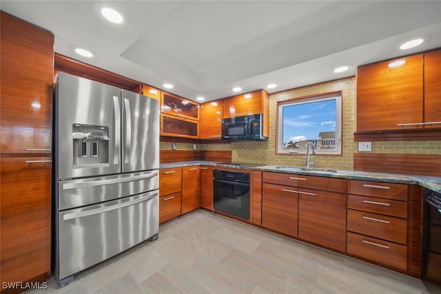 kitchen with sink, decorative backsplash, and black appliances