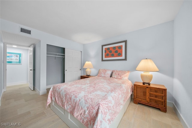 bedroom with light hardwood / wood-style floors and a closet