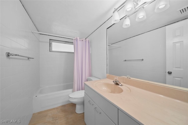 full bathroom with vanity, toilet, and shower / tub combo