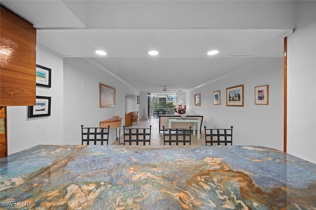 unfurnished dining area with crown molding and ceiling fan