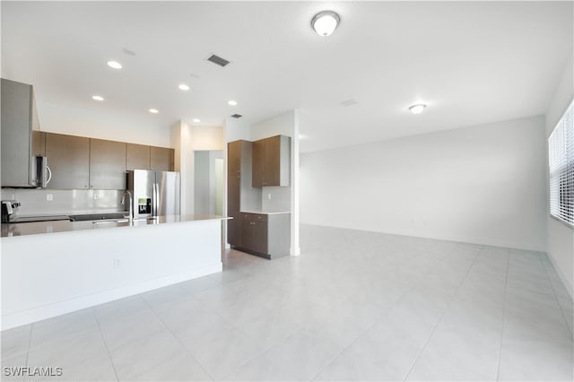 kitchen with light tile patterned floors and appliances with stainless steel finishes