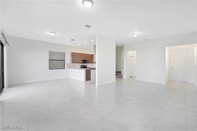 unfurnished living room featuring light tile patterned flooring