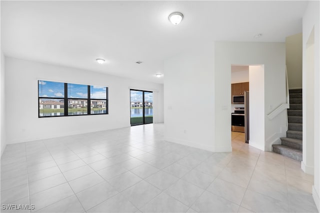 spare room featuring light tile patterned floors