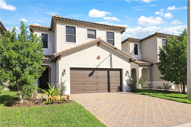 mediterranean / spanish home with a garage