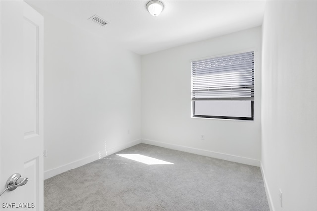 unfurnished room featuring light colored carpet