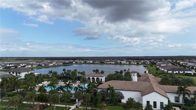 birds eye view of property with a water view