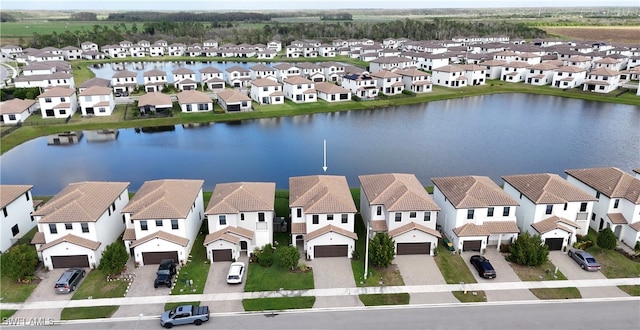 birds eye view of property with a water view