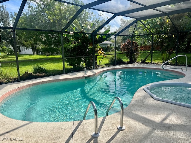 view of pool with a lawn, glass enclosure, and a patio