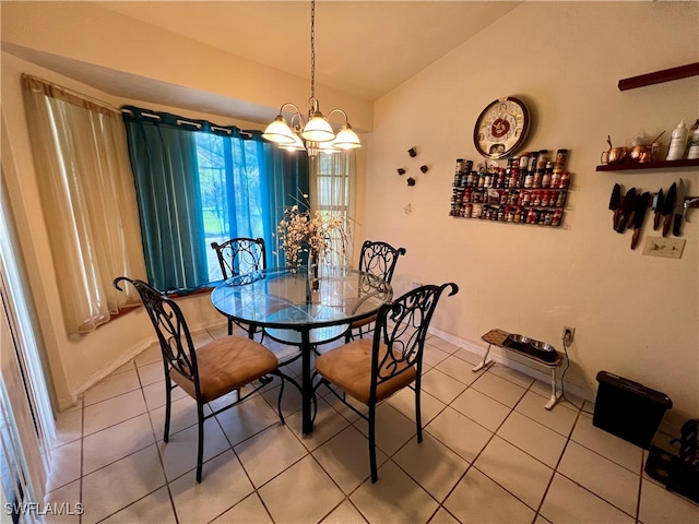 tiled dining space featuring a chandelier and lofted ceiling