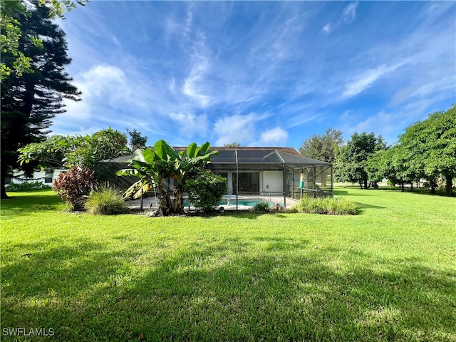 back of property featuring a yard and a lanai