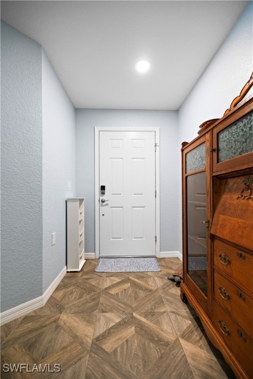 entrance foyer featuring dark parquet floors