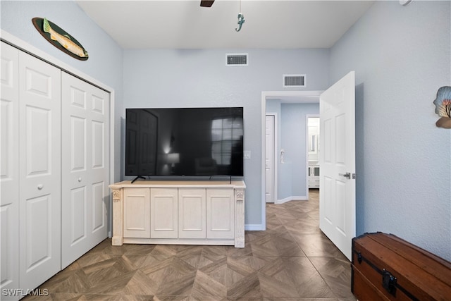 living room with ceiling fan and dark parquet floors